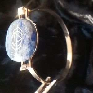 Gold tone bracelet with cats eye stone. Symbolizing the third eye chakra.